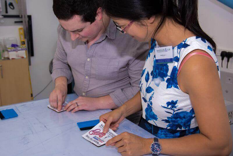 Guests having a go at making their own FASTSIGNS coaster
