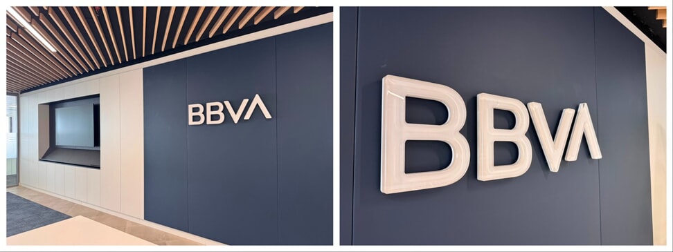 A collage of the BBVA interior wall-mounted signage against a blue wall.